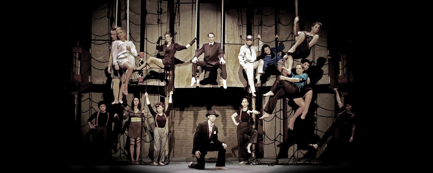 The full NOIR cast on stage at The Albany, with aerial rigging and cargo nets